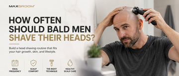 A bald man shaving his head with an electric head shaver in front of a bathroom mirror, illustrating how often bald men should shave their heads and build a comfortable head shaving routine.